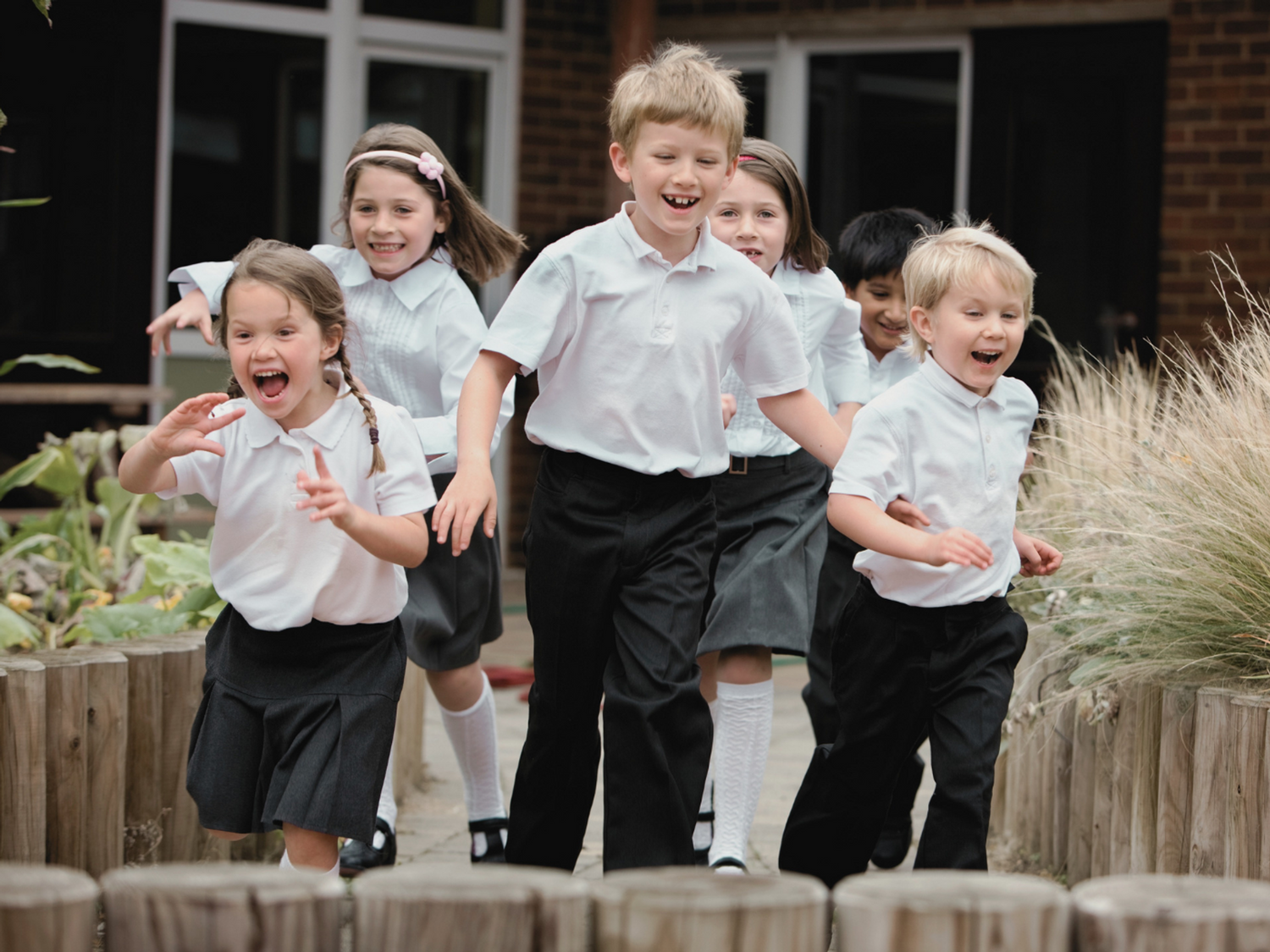 Students running outside of their school