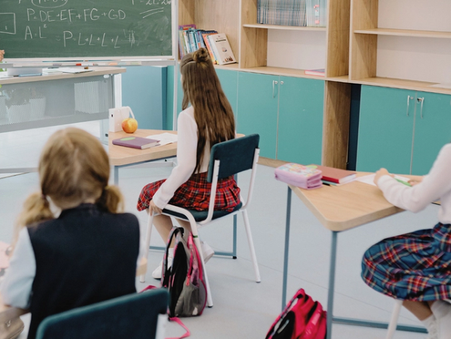 Students listening to a teacher in a classroom