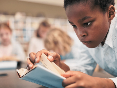 A student reading independently in the classroom
